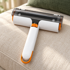 White and orange reusable pet hair roller on a cream linen sofa